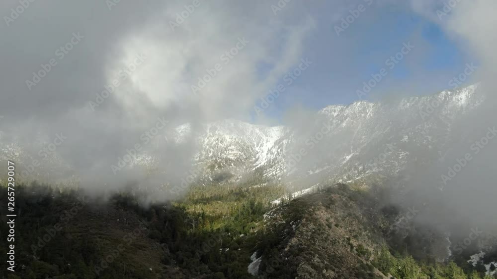 Flying Above Clouds Aerial Shot of Winter Mountain Forest Flying Above Clouds Aerial Shot of Winter Mountain Forest