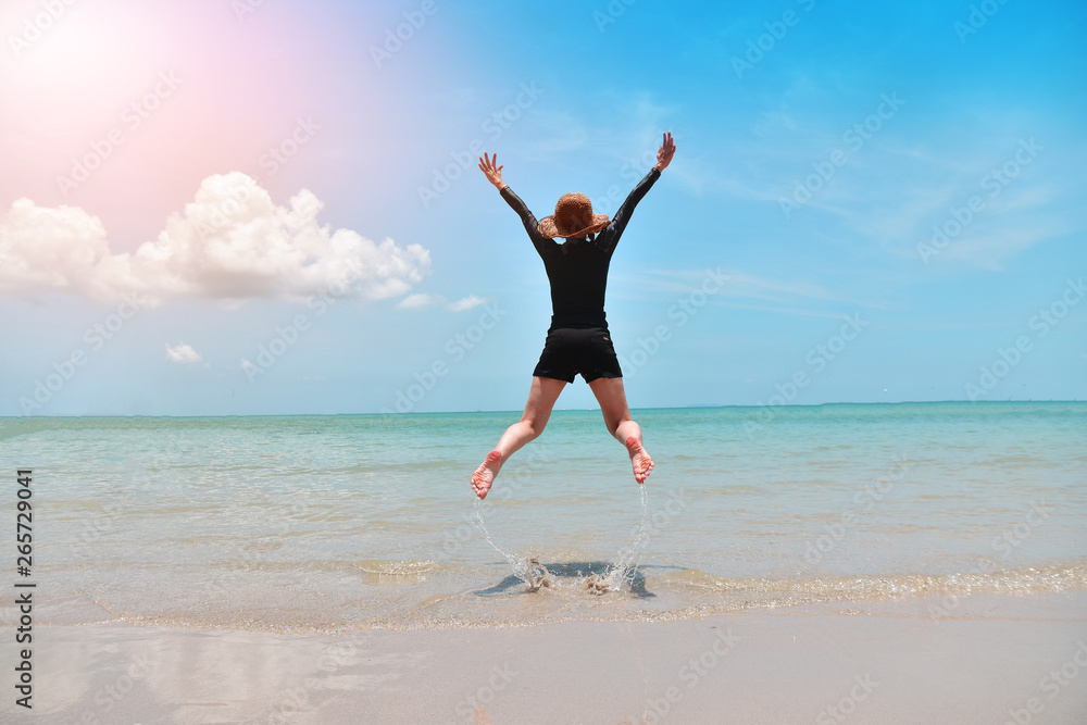 Women jumping on beach at sea and Blue sky Women jumping on beach at sea and Blue sky
