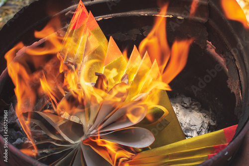 Closeup burning Joss paper or Hell Bank Note for ancestors in Chinese new year or Tomb Sweeping Day.