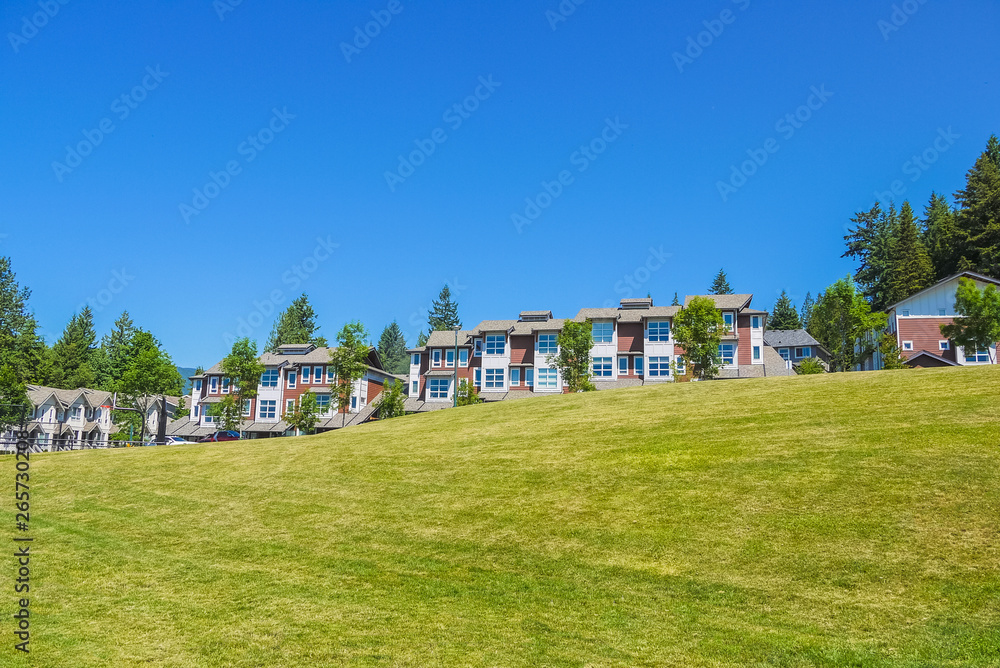 Row of new townhouses on top of the hill on sunny day in British Columbia Row of new townhouses on top of the hill on sunny day in British Columbia