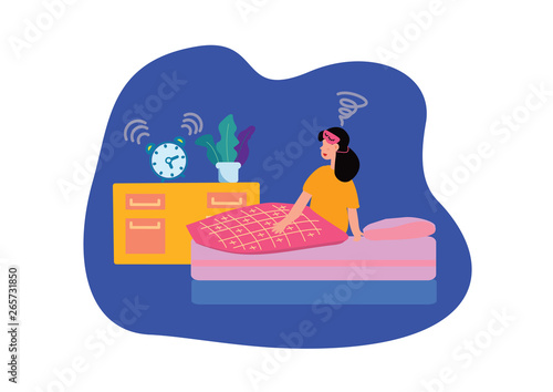 woman waking up in the morning with alarm clock ringing 