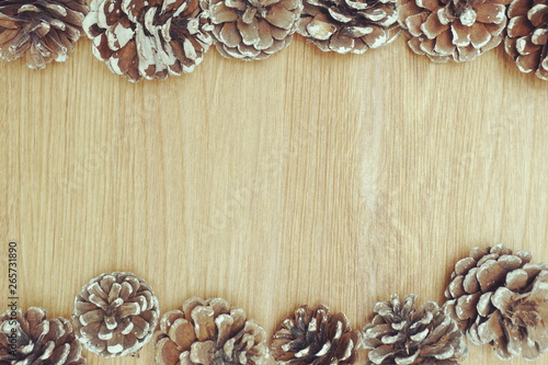 Holiday decoration with Rustic wooden background with pine cones