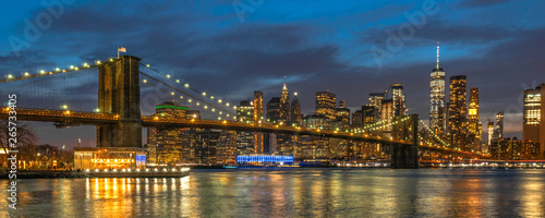 Banner and cover scene of New york Cityscape with Brooklyn Bridge over the east river at the twilight time  USA downtown skyline  Architecture and transportation concept