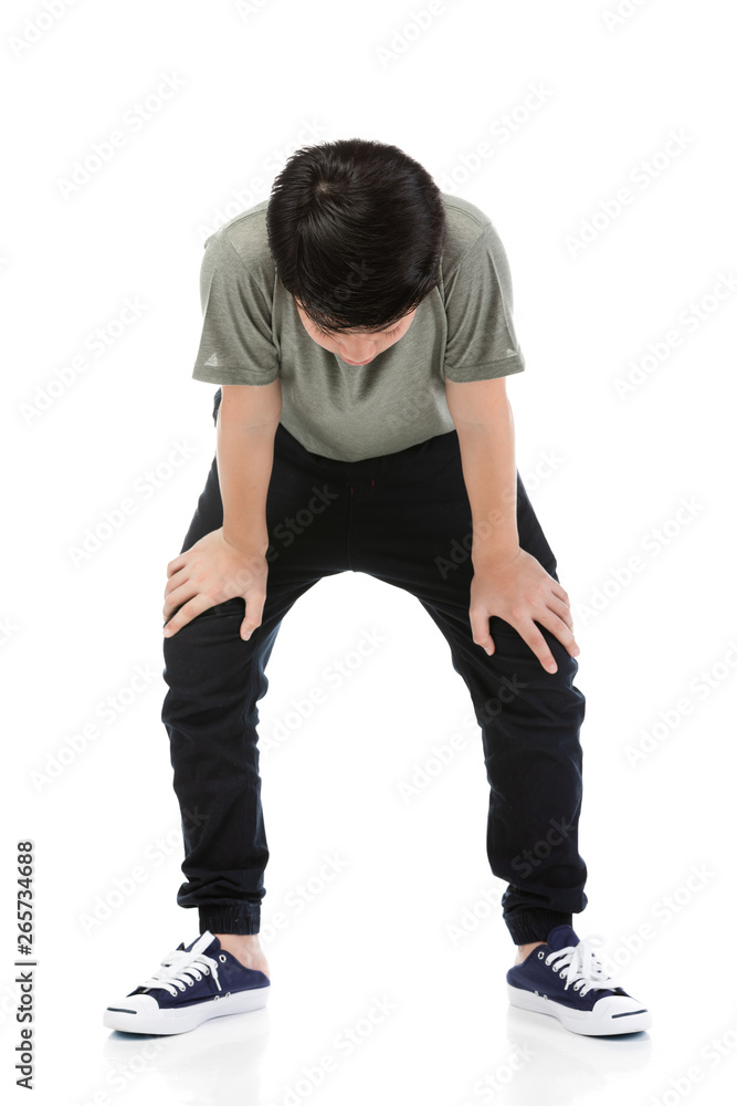 Naklejka premium Young Asian boy over white background, be upset; have a bad temper emotional.