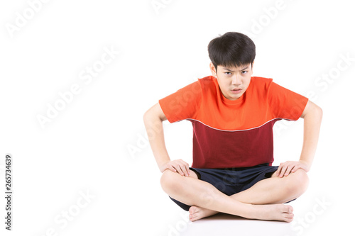 Portrait Young Asian angry boy sitting over white background,