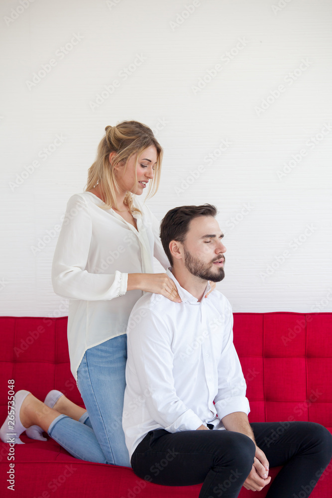 woman with a shoulder massage, use the hips on the sofa. Relaxing Concept woman with a shoulder massage, use the hips on the sofa. Relaxing Concept