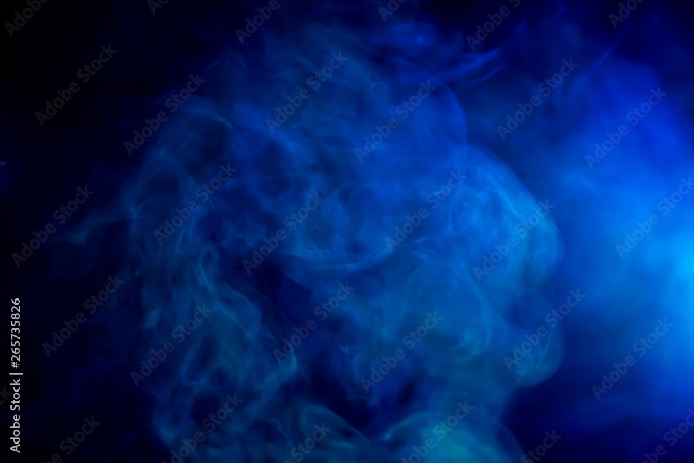 Fototapeta premium blue smoke texture with light shine beam at dark black room .