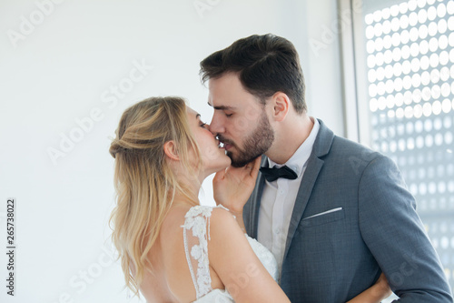 Young couples are kissing on the wedding day. The concept is happy in love.