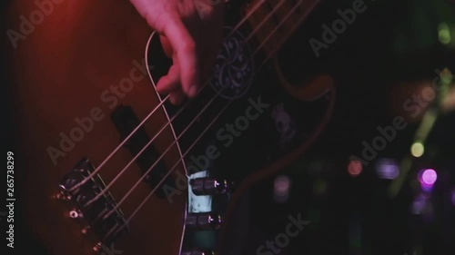 A man palying on a gibson electric guitar in other perspective view. photo