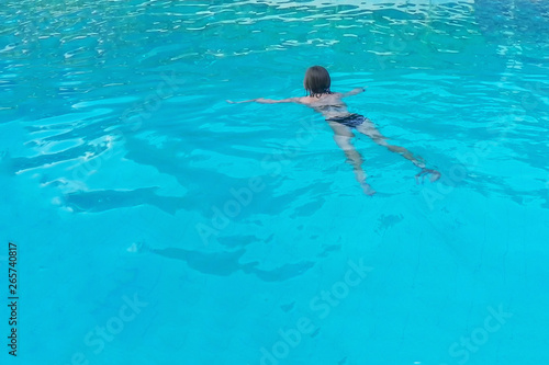  ..Young woman swims in the pool