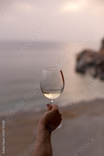 Female hand holding a glass of white wine