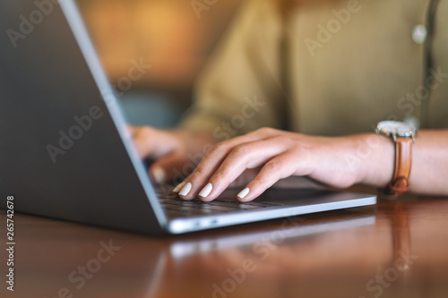 Closeup image of woman s hands using and typing on laptop computer keyboard