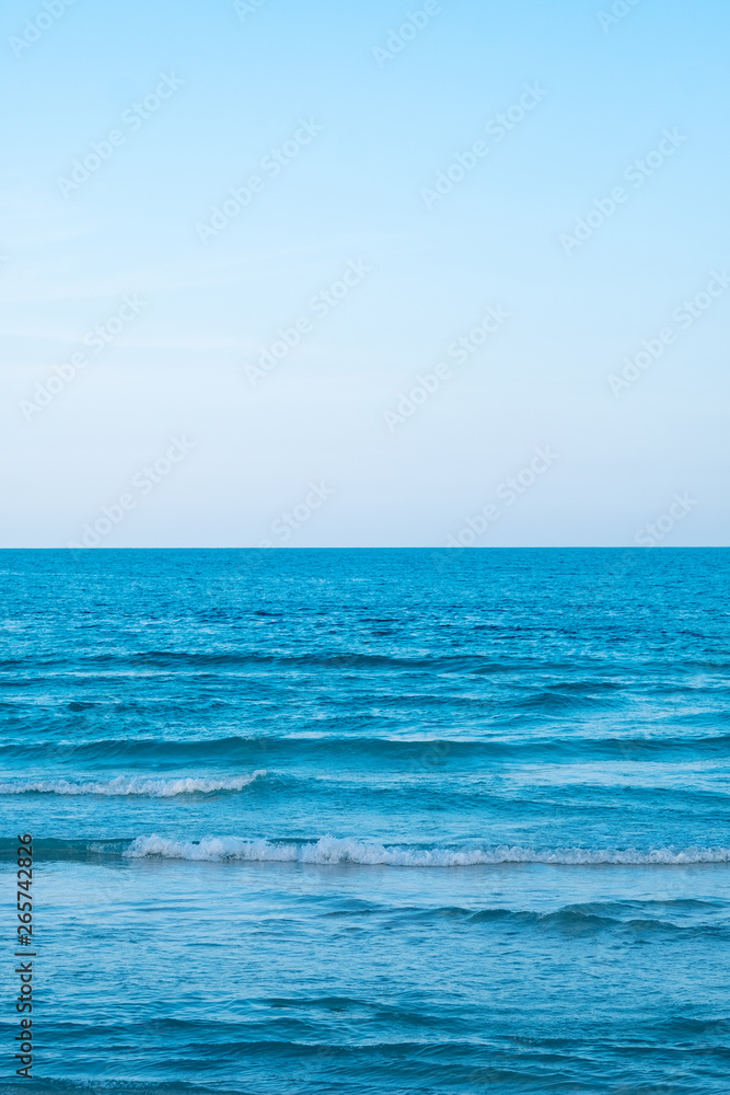 Landscape image of tropical white beach with blue sky background