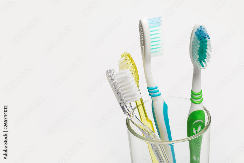 Set of toothbrushes in glass on white background. Set of toothbrushes in glass on white background.
