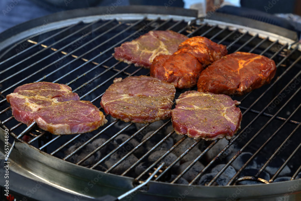 Meat and sausages are fried on the grill Meat and sausages are fried on the grill