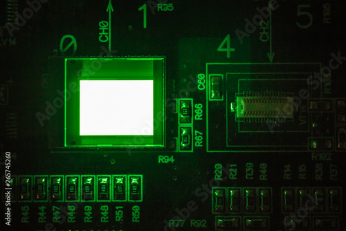 The process of checking several oled displays on the test station. Displays glow brightly of green color close up.