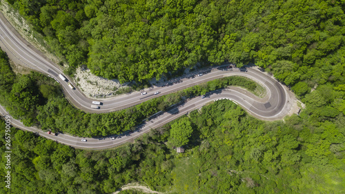 Drone view of a curved winding road trough the mountains