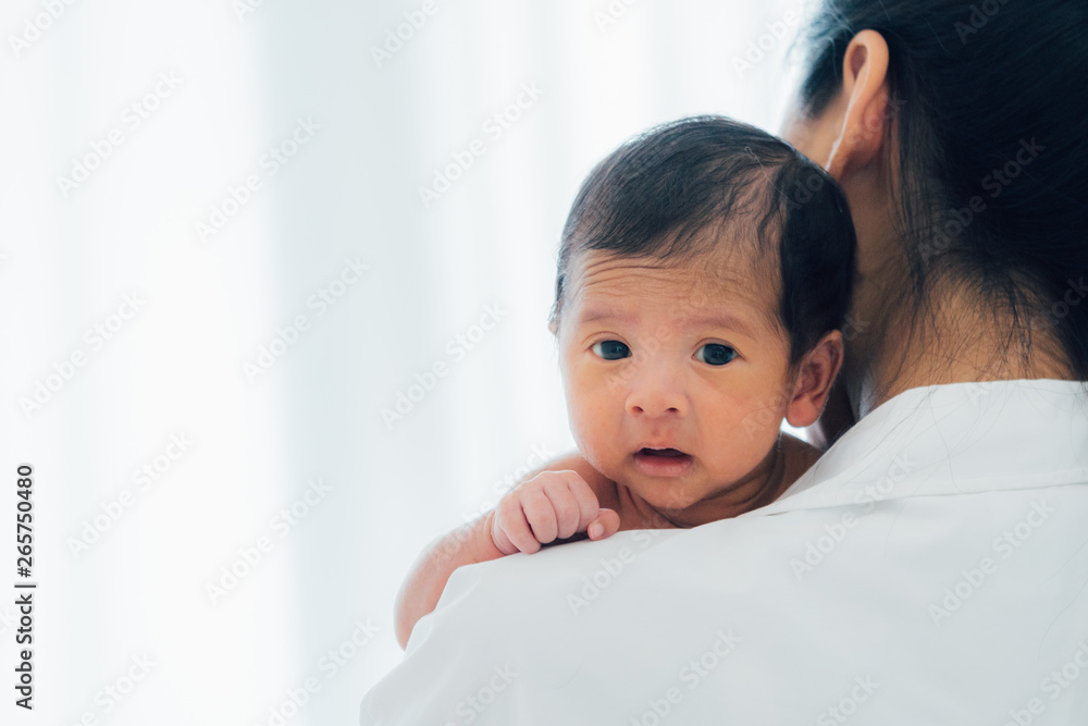 Asian newborn baby with mother concept : young mother breast feeds newborn in living room Asian newborn baby with mother concept : young mother breast feeds newborn in living room