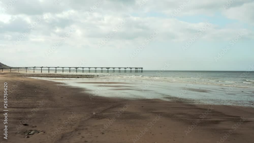 Aerial Dolly Shot of Saltburn Beach towards Ocean on Spring Day Aerial Dolly Shot of Saltburn Beach towards Ocean on Spring Day