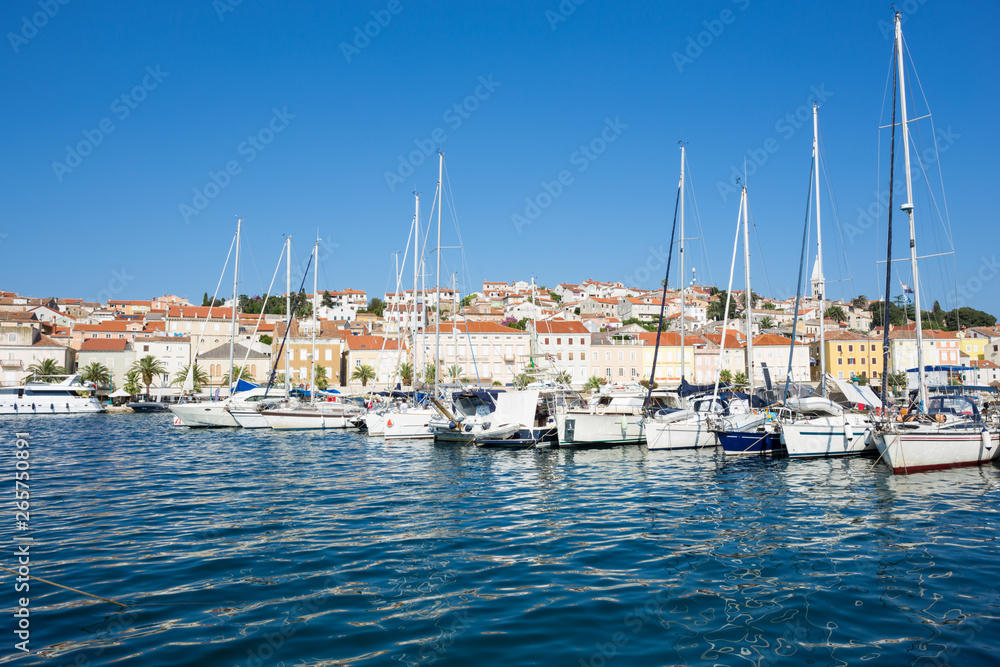 yachts moored at the pier in harbour of Losinj town, Croatia.