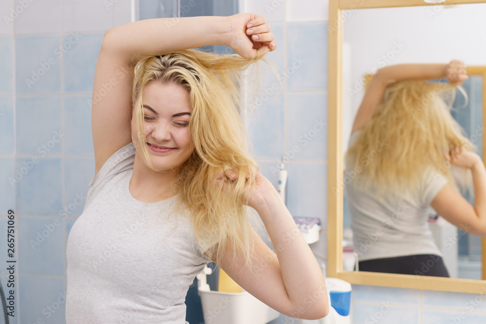 Happy fresh blonde woman in bathroom