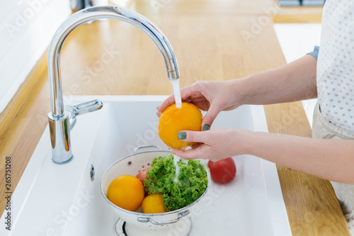Woman hands washing fresh vegetables