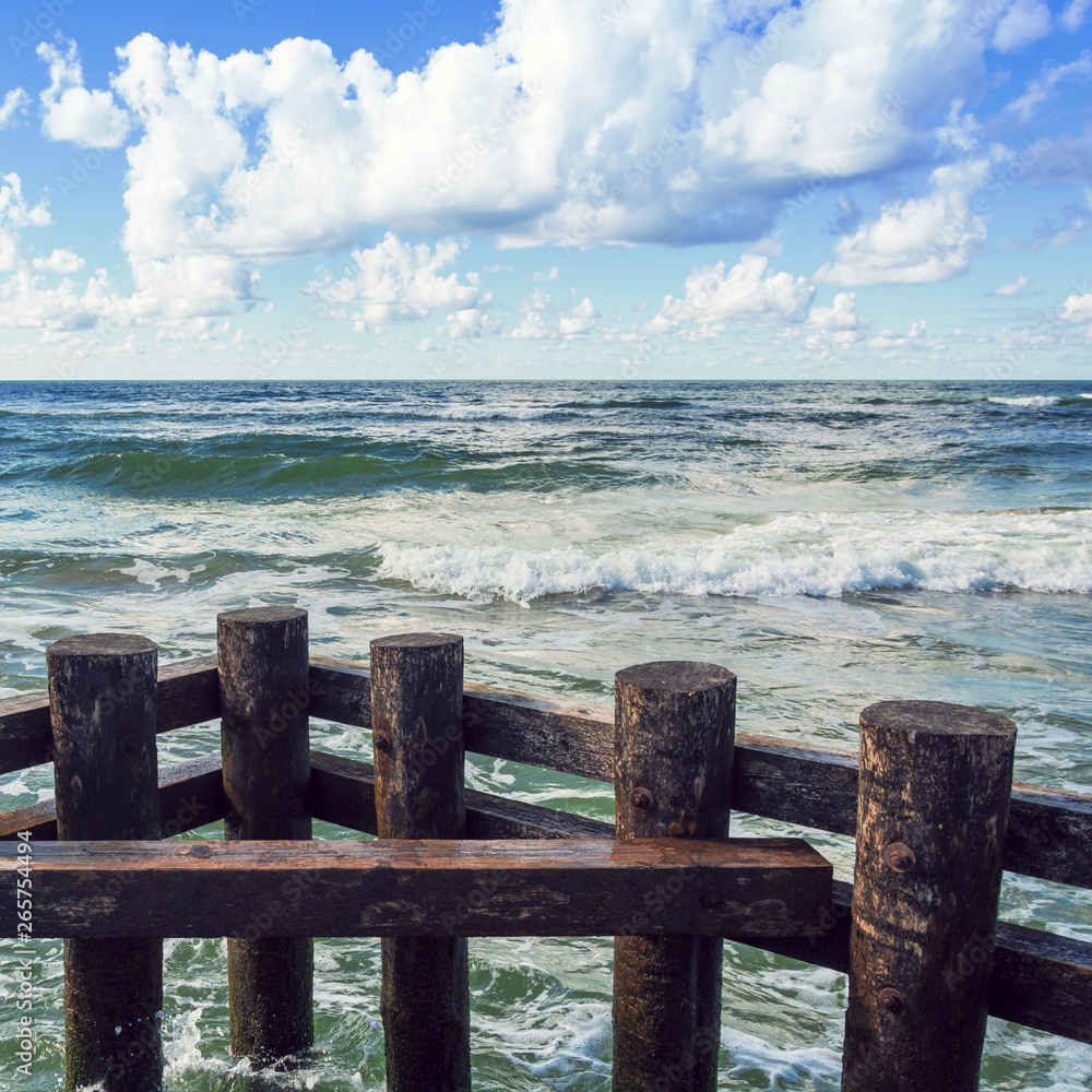 horizontal line of sea waves and wooden balls square