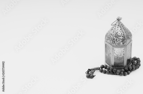 Lantern and rosary beads or tasbih on black and white. Selective focus, copy space and Ramadan Kareem concept