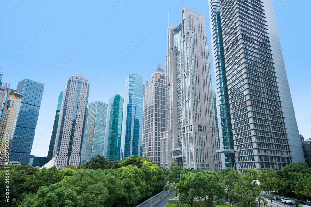 The pedestrian pavement under the tall building large building.