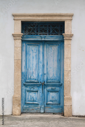wooden vintage front door with a metal lattice
