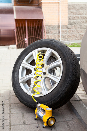 Dismounted car allow wheel rim with tire ready for inflate a tyre with pneumatic pump
