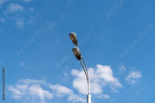 Street light against the blue sky with clouds. Copy space.