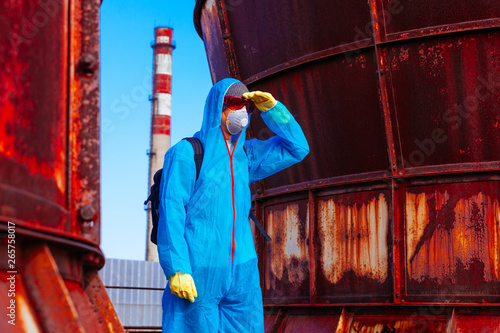 man environmental mask face pack disguise facemask bitmask protective overall blue orange rast plant factory disused catastrophe photo