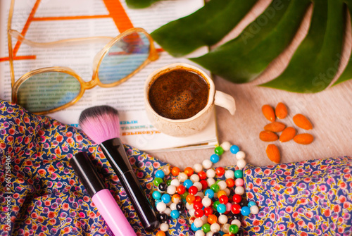 Relaxing morning time with cup of coffe and magazine. Closeup, woman lifestyle.