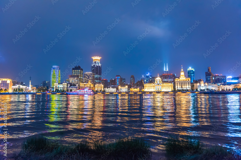 The bund of Shanghai huangpu river of tall buildings in the evening.