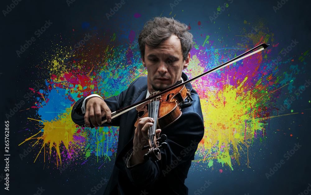 Fototapeta premium Young classical violinist musician with colorful splotch wallpaper 
