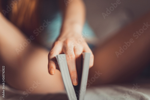 Vagina symbol. Two fingers on book on bed. Woman read love novel. Sex concept. Womens secrets. Reading is sexy photo