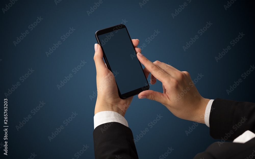 Mockup for female hand using frameless smartphone with dark background
Mockup for female hand using frameless smartphone with dark background