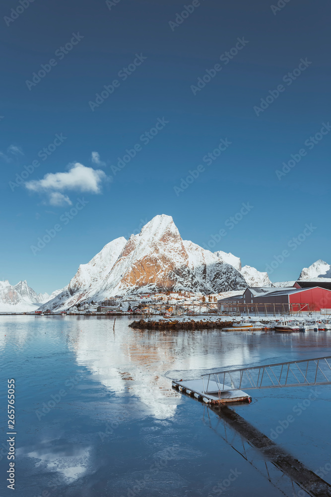 Very beautiful bay in the sea with small red houses on the coast, small jetty for fishing boats