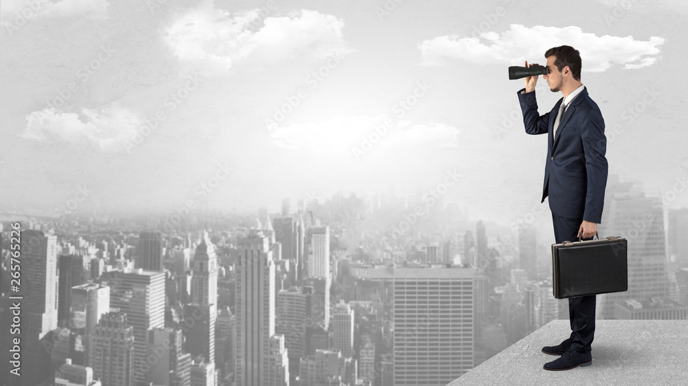 Businessman looking forward to a city with binoculars from skyscraper concept
Businessman looking forward to a city with binoculars from skyscraper concept