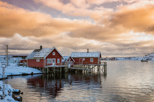Beautiful contrasting red houses on the coast of the bay, winter sunrise © varenyk