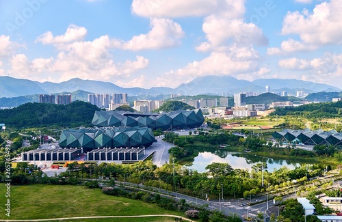 Vibrant panoramic view of typical Chinese landscape with residential buildings and high ways in sunny day in Shenzhen