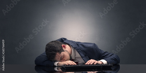 Young businessman fell asleep at his workplace with copy space