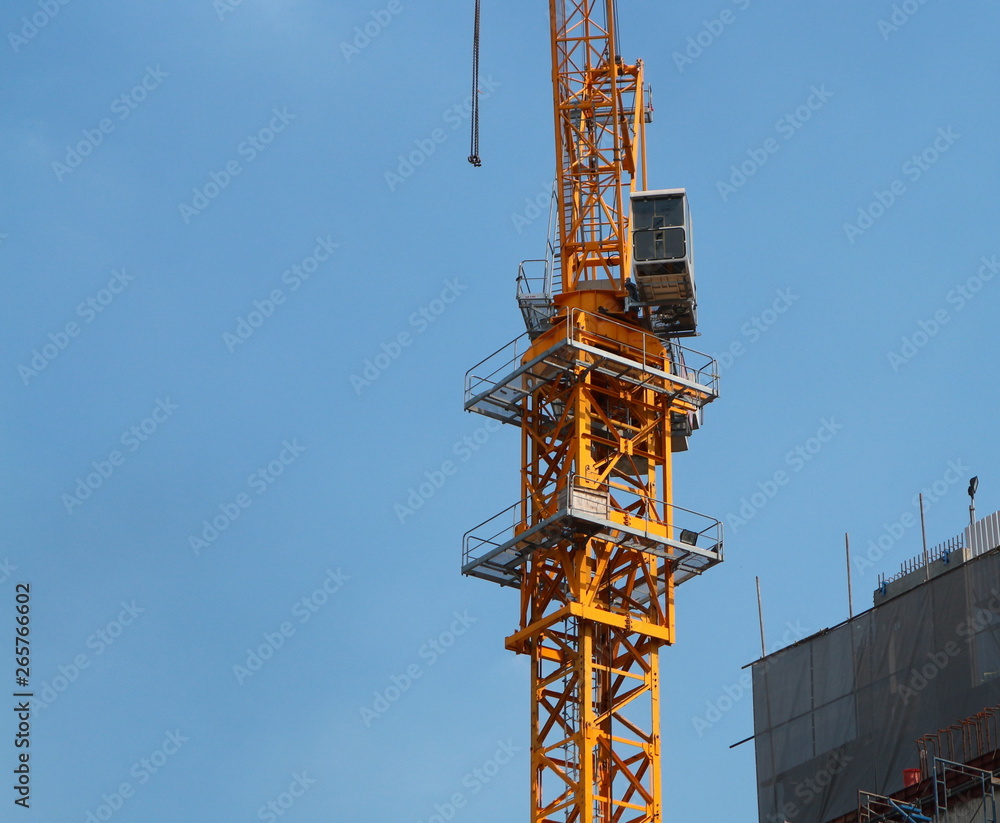 A crane stands near a building under construction A crane stands near a building under construction
