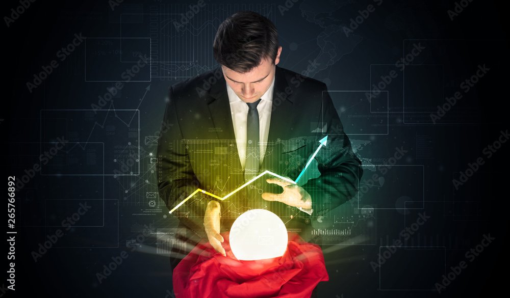 Young businessman making predictions of the future of the stock market with a magic ball