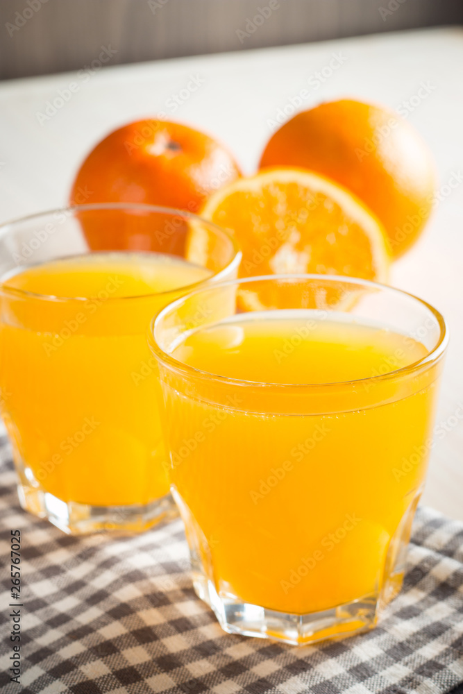 Photo of fresh orange juice in the glass jar. Summer healthy organic drink concept. Cold beverages with ice and orange fruits. Photo of fresh orange juice in the glass jar. Summer healthy organic drink concept. Cold beverages with ice and orange fruits.
