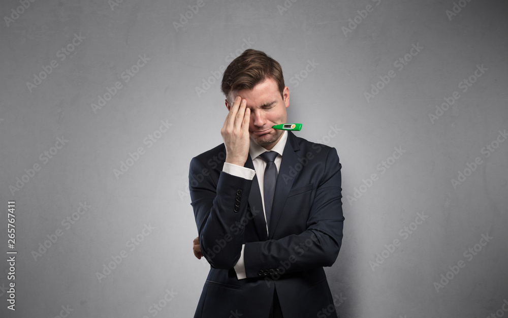 Young tired businessman with thermometer and copy space
Young tired businessman with thermometer and copy space