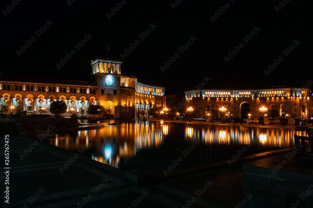 Yerevan, Armenia - 18 APR 2019: Yerevan city center, Republic square with fountain and parliament building in the background. Night photography - Image