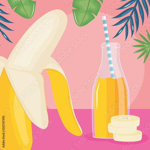 fresh banana slices juice fruit in botttle with straw in leafs palms
