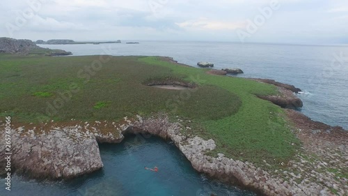 Aerial pull back shot of the Isla Redonda with the famous hidden beach, Marietas Islands, Nayarit, Mexico photo